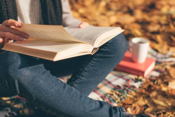 A person reads books for personal success and self-help