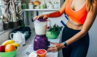 Straight-belly woman mixes smoothies in blender